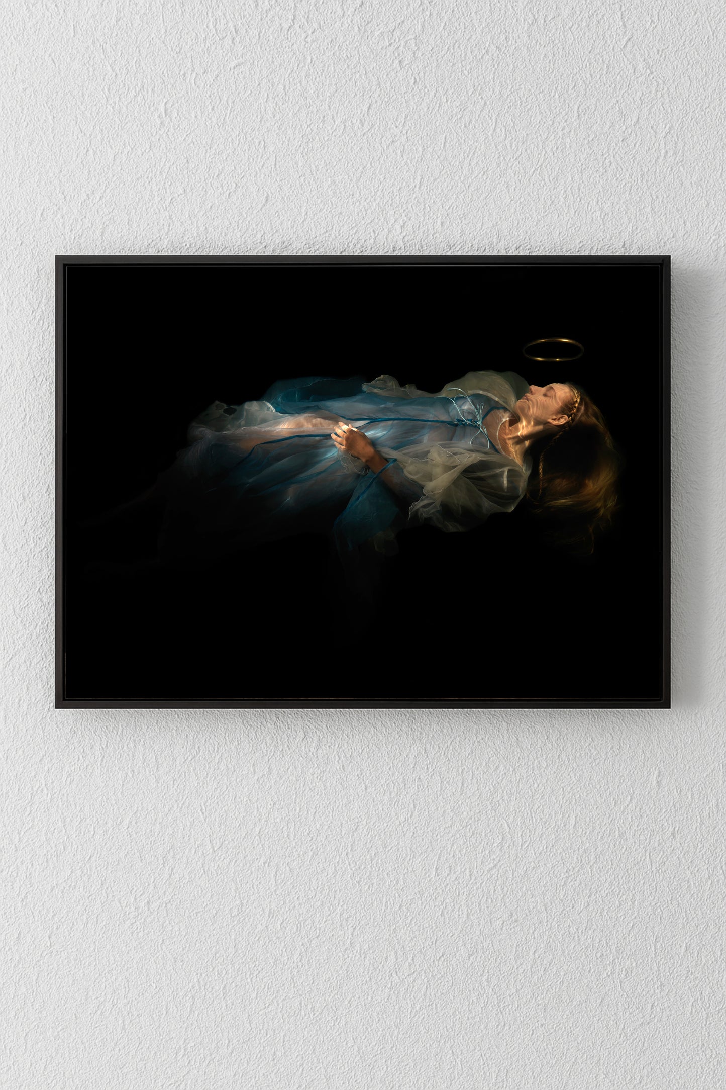 Unique archival pigment print of a reclining woman in a flowing blue dress on a black background.