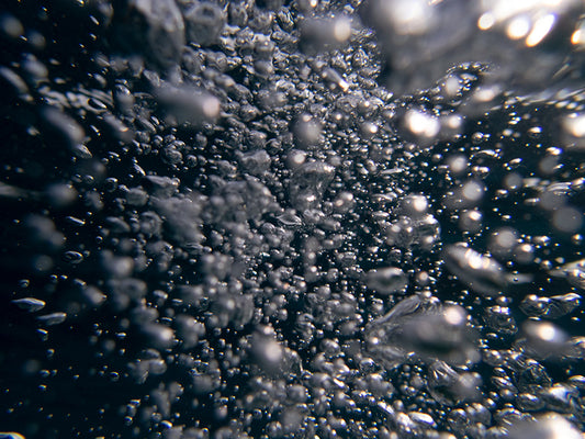 Transparent Bubbles in Sunlit Waters
