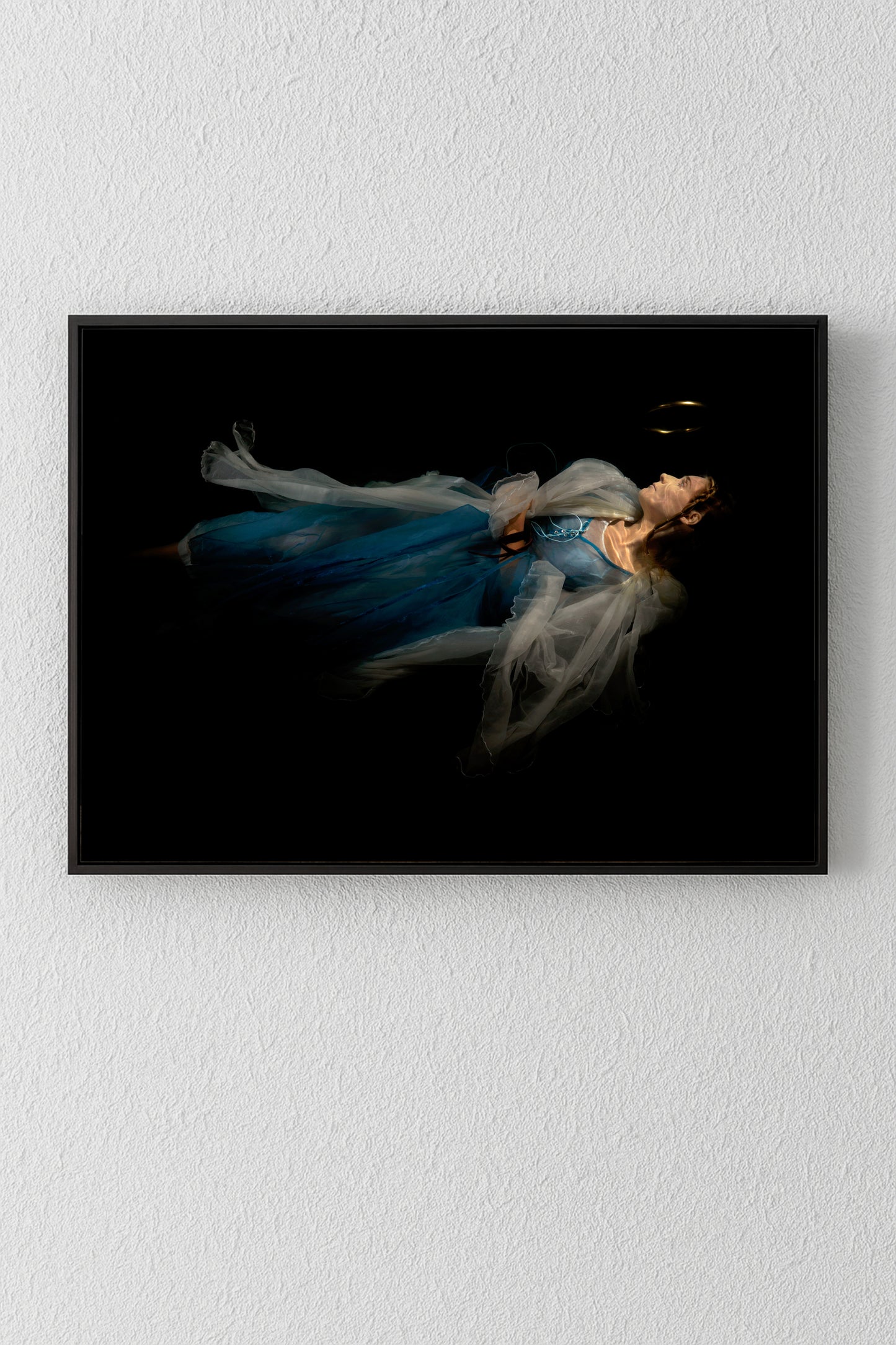 Unique archival pigment print of a woman in flowing blue dress against black background.