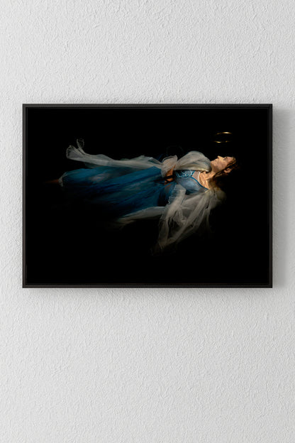 Unique archival pigment print of a woman in flowing blue dress against black background.