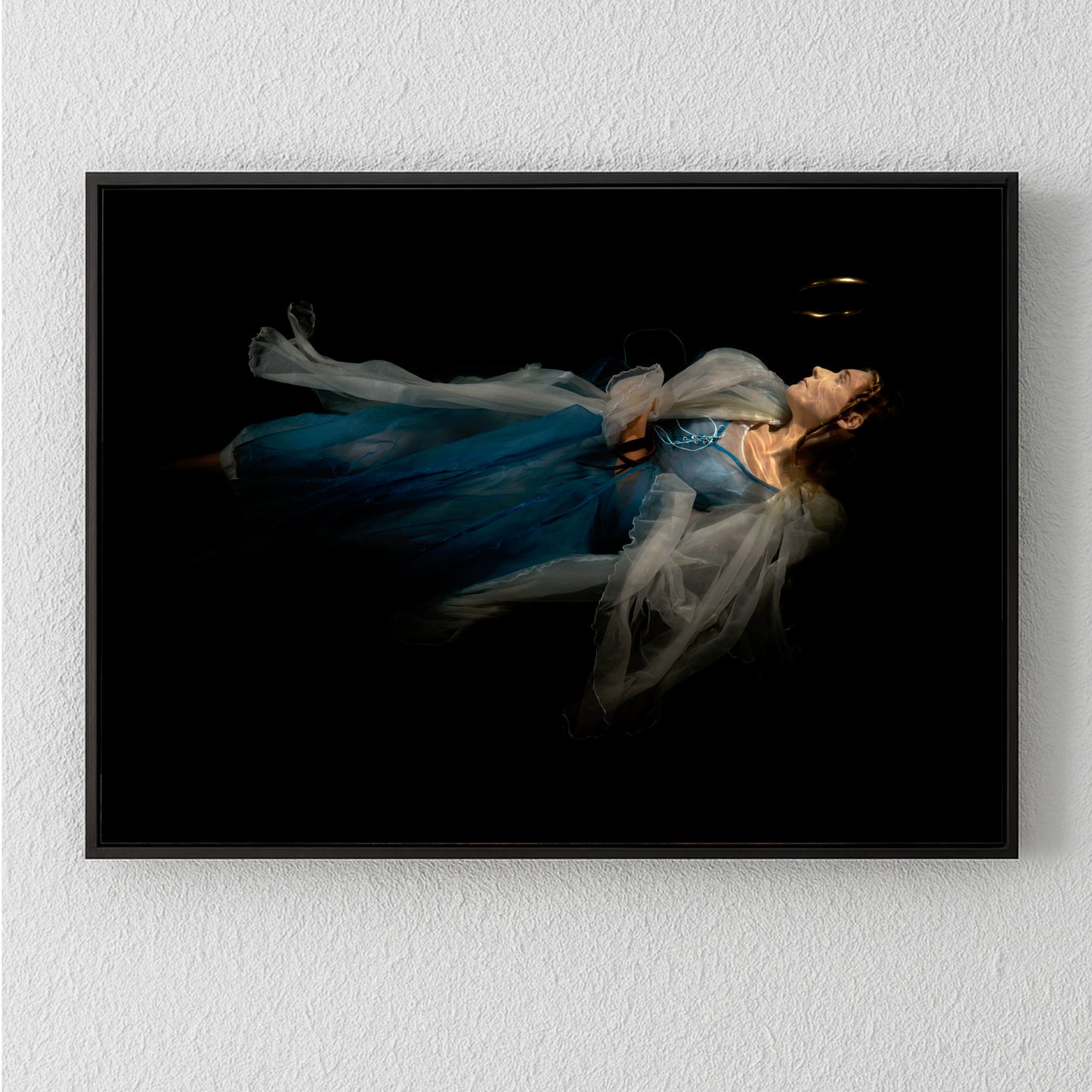 Unique archival pigment print of woman in flowing blue dress on black background.