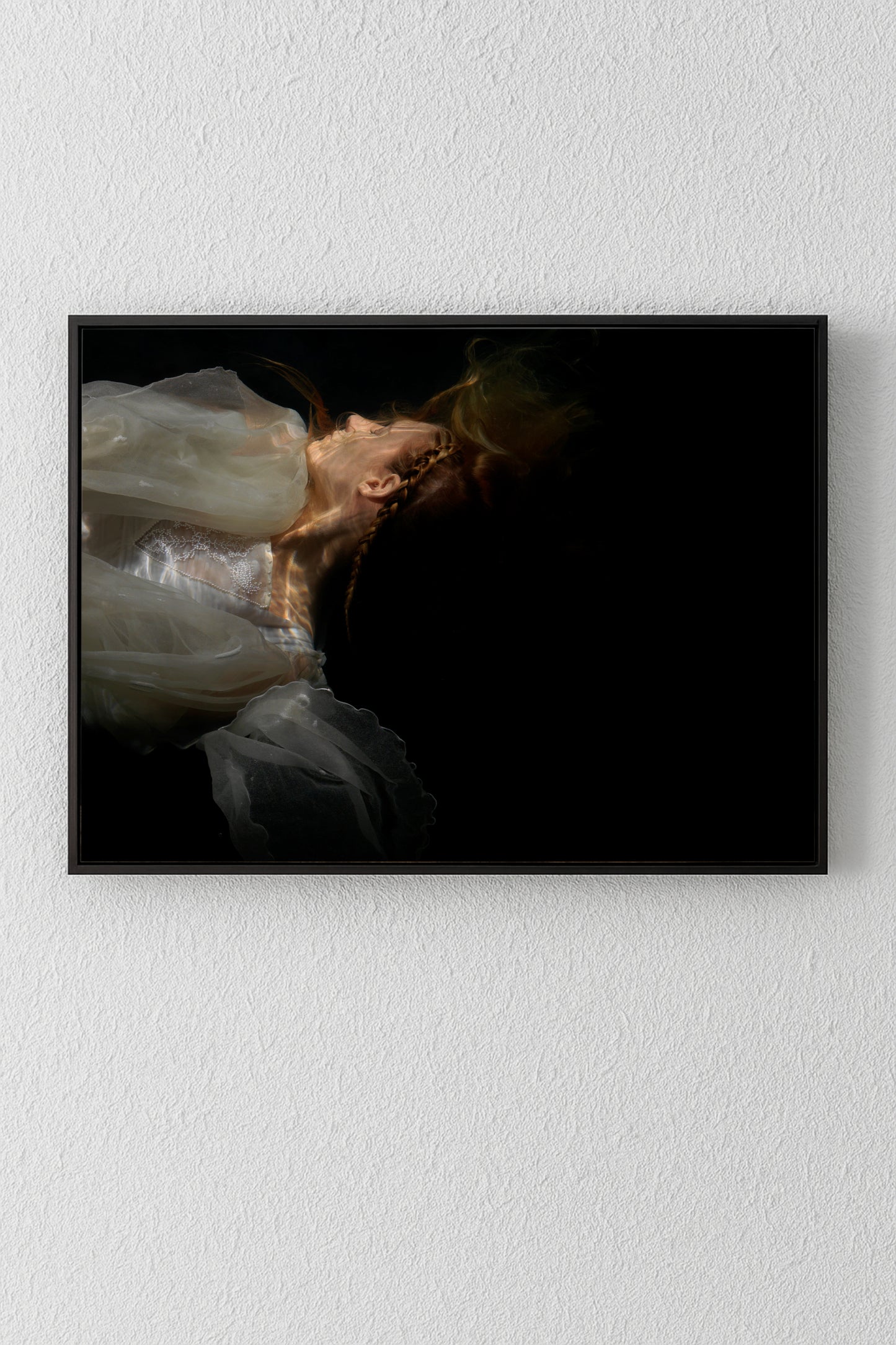 Unique archival pigment print of a woman in a white dress against a black background.