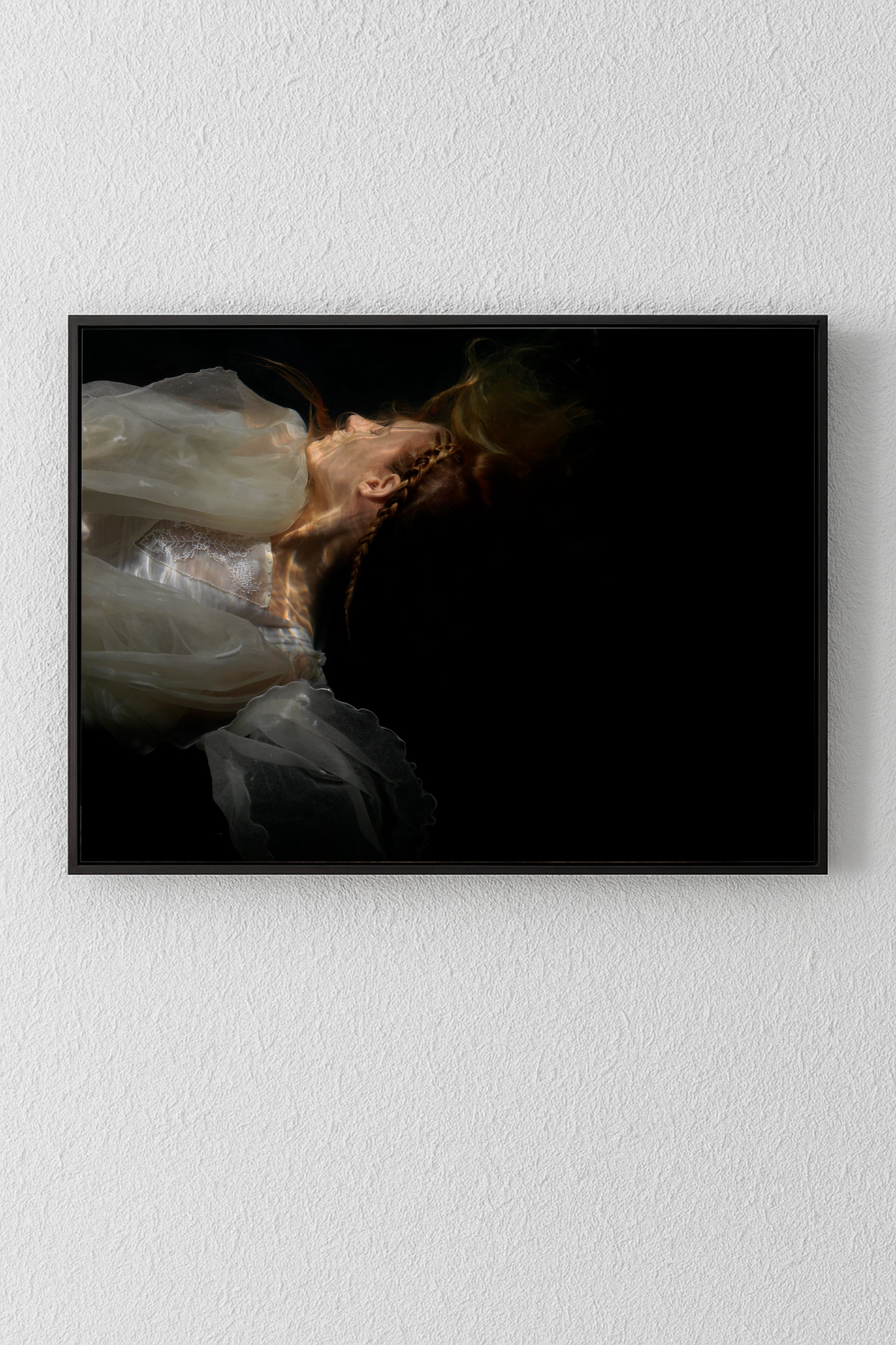 Unique archival pigment print of a woman in a white dress against a black background.