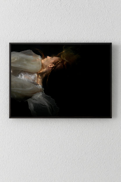 Unique archival pigment print of a woman in a white dress against a black background.