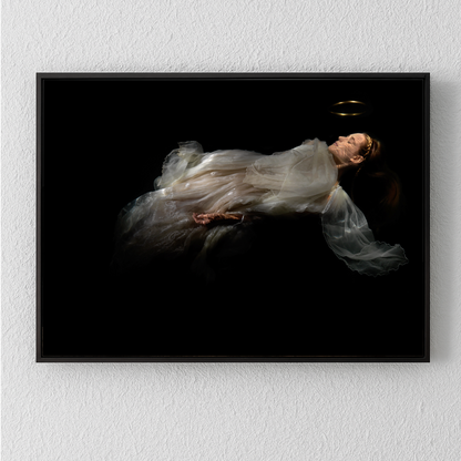 Unique archival pigment print of a woman floating in sheer white fabric against a black background.