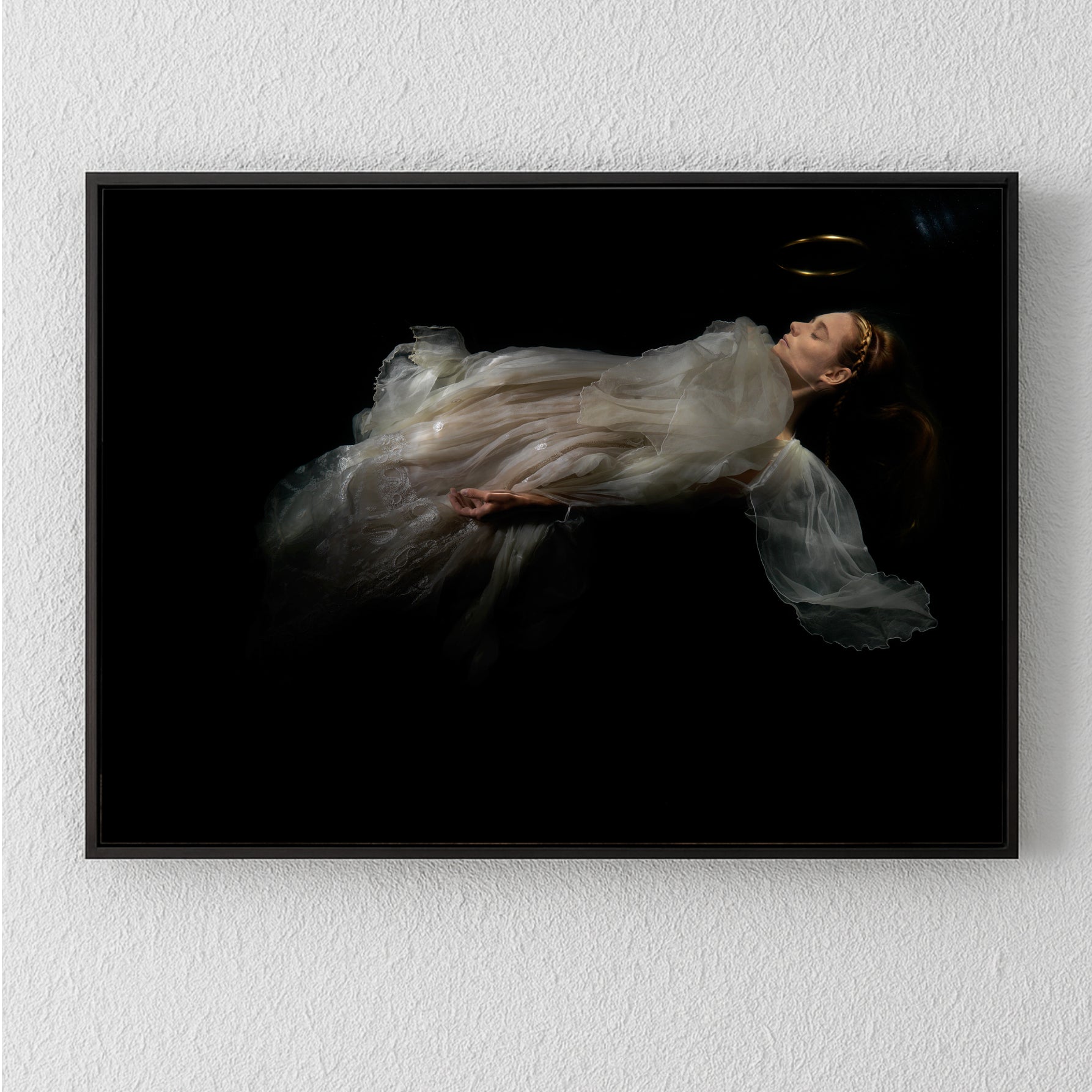Unique archival pigment print of a woman floating in sheer white fabric against a black background.