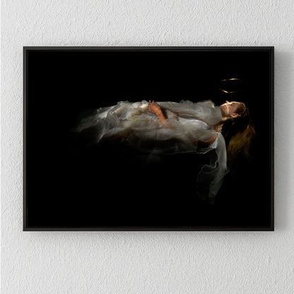 Unique archival pigment print featuring a softly lit figure in flowing white fabric on black background.