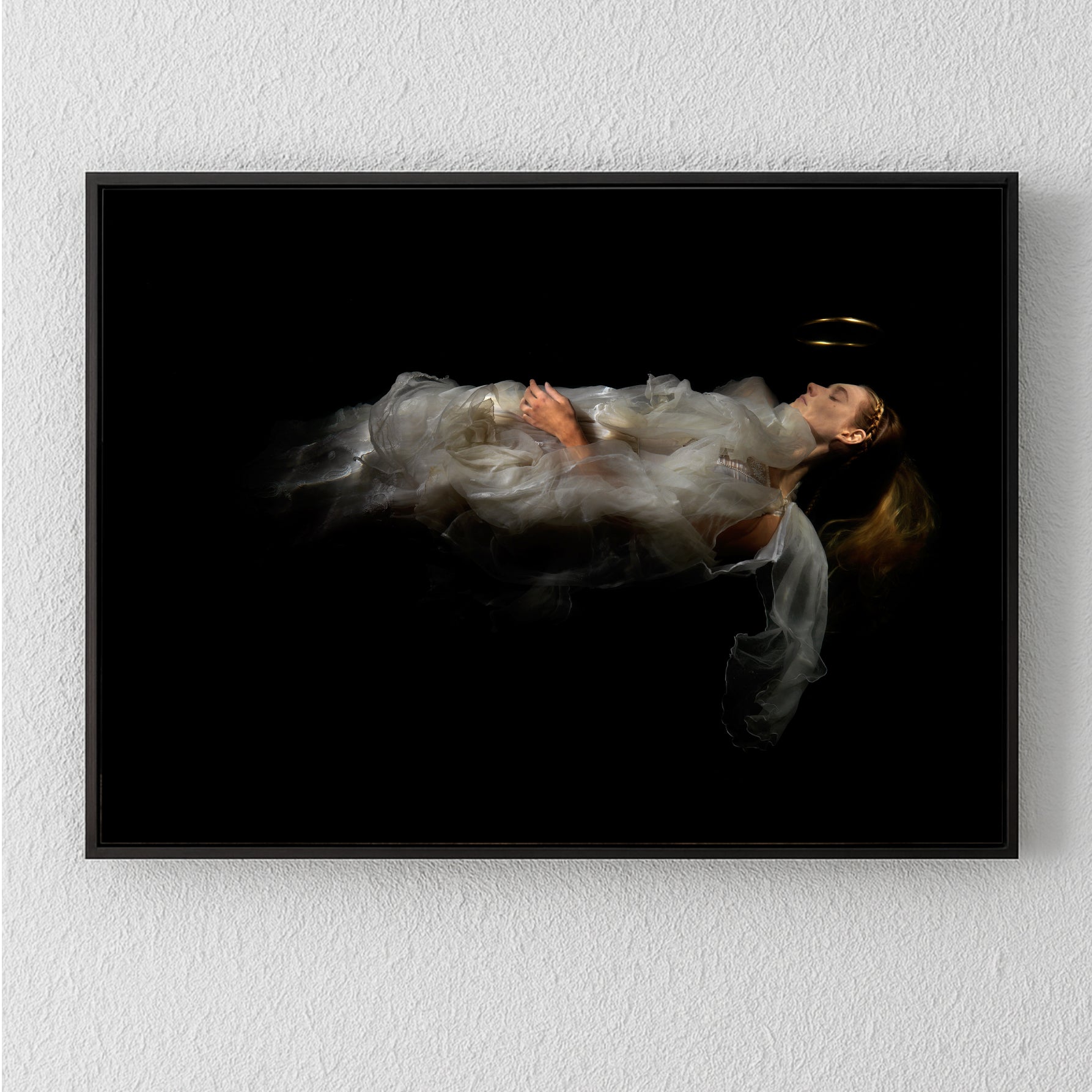 Unique archival pigment print of a woman in flowing white fabric floating against a black background.
