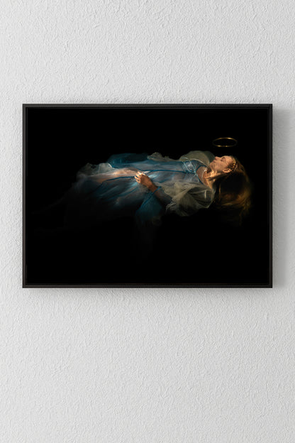 Unique archival pigment print of a reclining woman in a flowing blue dress on a black background.